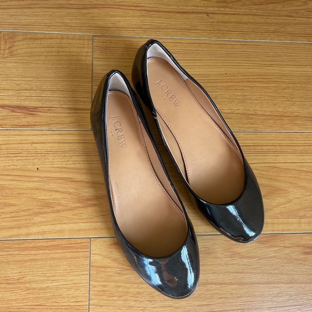 J crew patent leather flats with a short gold accent heel.